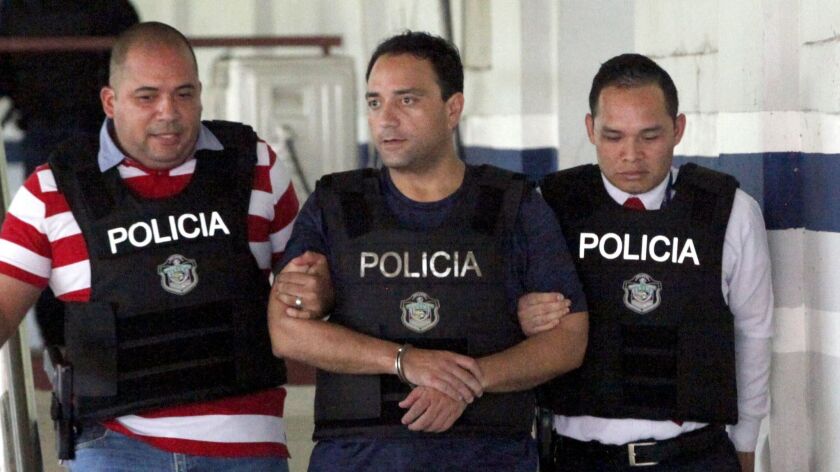 Roberto Borge, a former governor of the Mexican state of Quintana Roo, is escorted by Panamanian police after being arrested in Panama City on Monday.