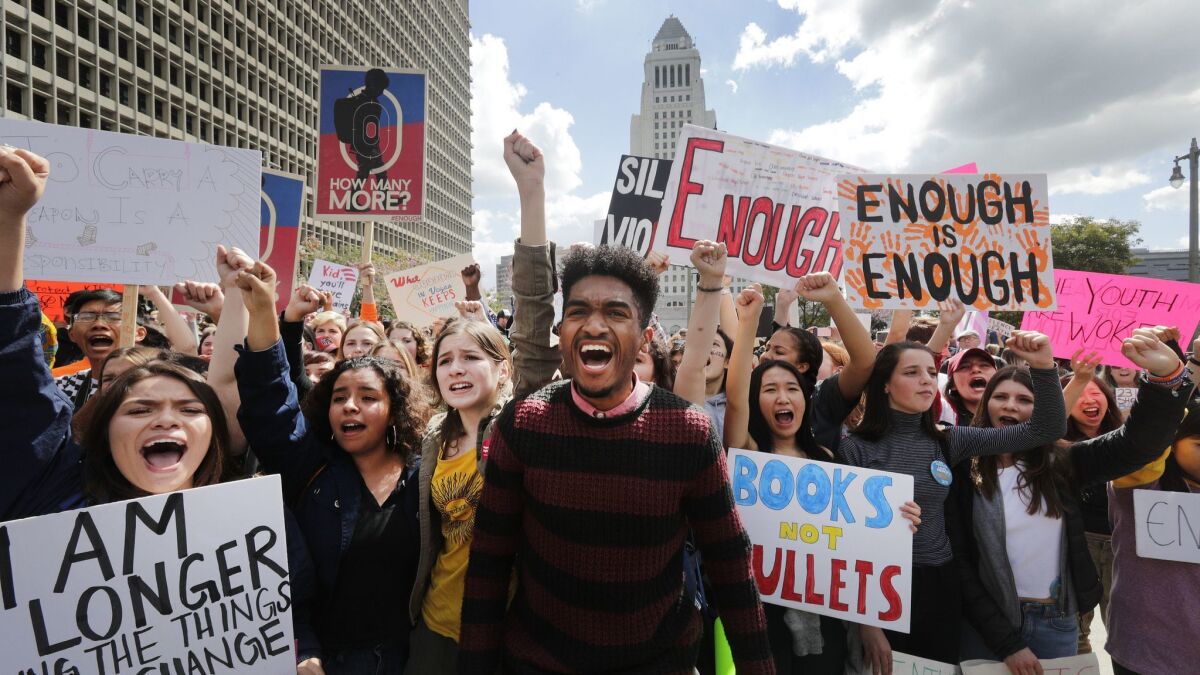 Students lead a chant against gun violence as thousands of protesters march in the streets during the March for Our Lives on March 24 in Los Angeles.