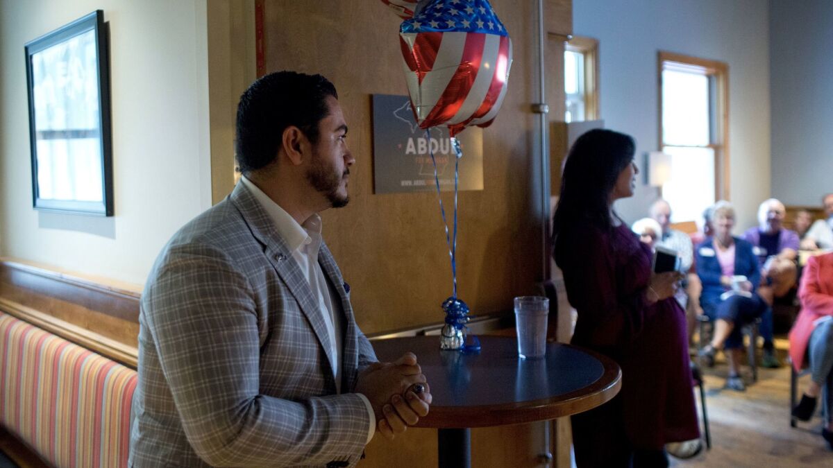 El-Sayed awaits his introduction at a private reception in Holland, Mich.