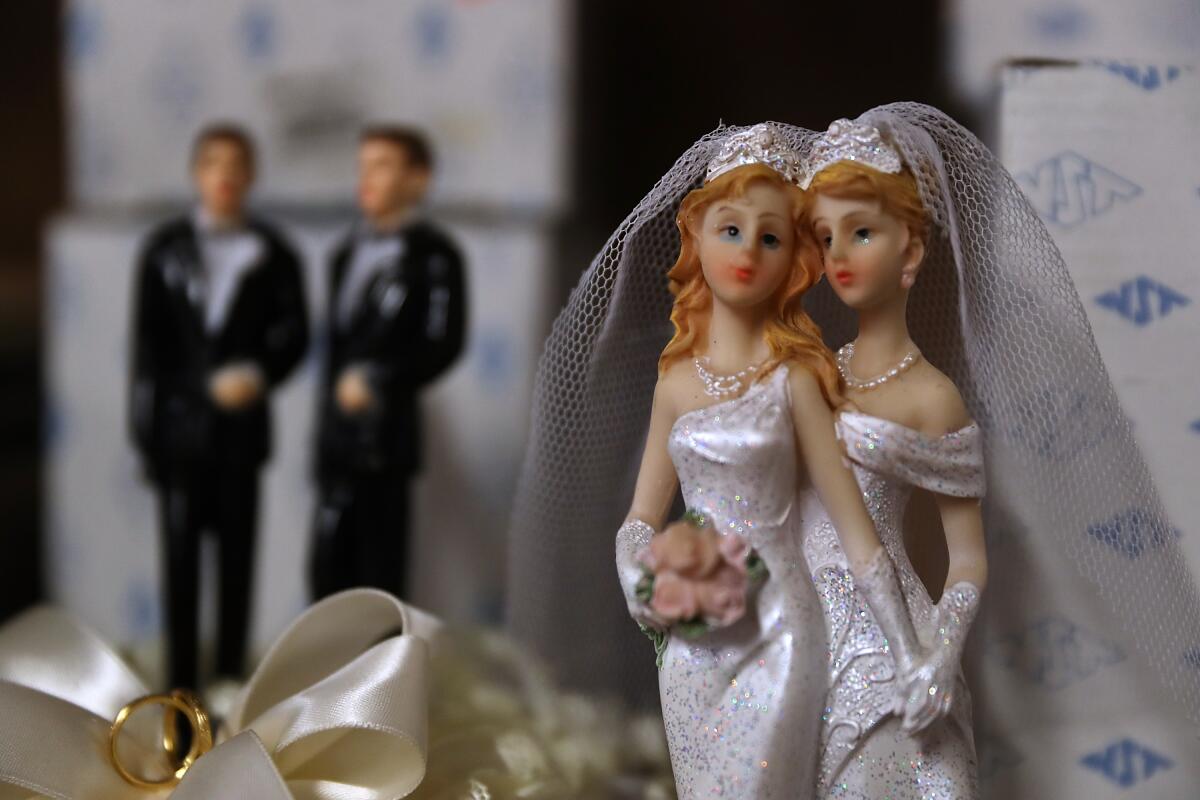 Same-sex marriage cake toppers are displayed on a shelf in San Francisco.