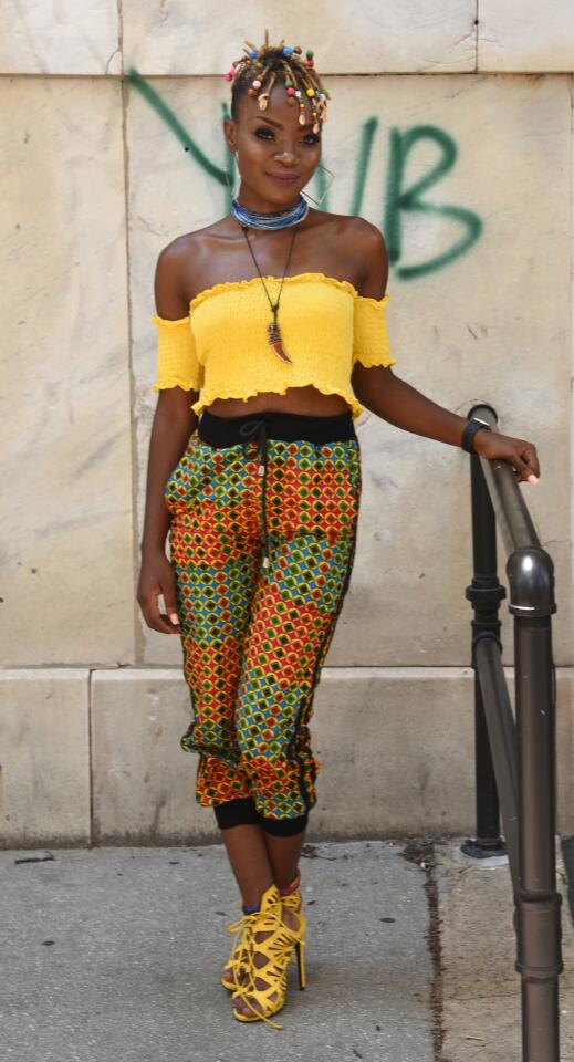 Who: Olubunmi Ayegbajeje, 25, Hyattsville resident, clothing designer/stylist Spotted at: For the Culture: Africana Pop-Up event at Tightfisted Fashion: Resale & Consignment Store What she wore: IVIVI sunflower color smocked cropped top she found at a flea market; multicolor Ankara waxed cotton joggers she designed and made; yellow cage sandals from justfab.com; horn necklace she bought in Nigeria; waist beads from her own line that she wrapped to create a necklace (“I never take it off”); rose gold Apple watch; and square hoop earrings from Olive Ole. Her style preference: “I’m not one of those people who’s always trying to show off their form. I’d rather show my colors; the colors I feel from the inside.”