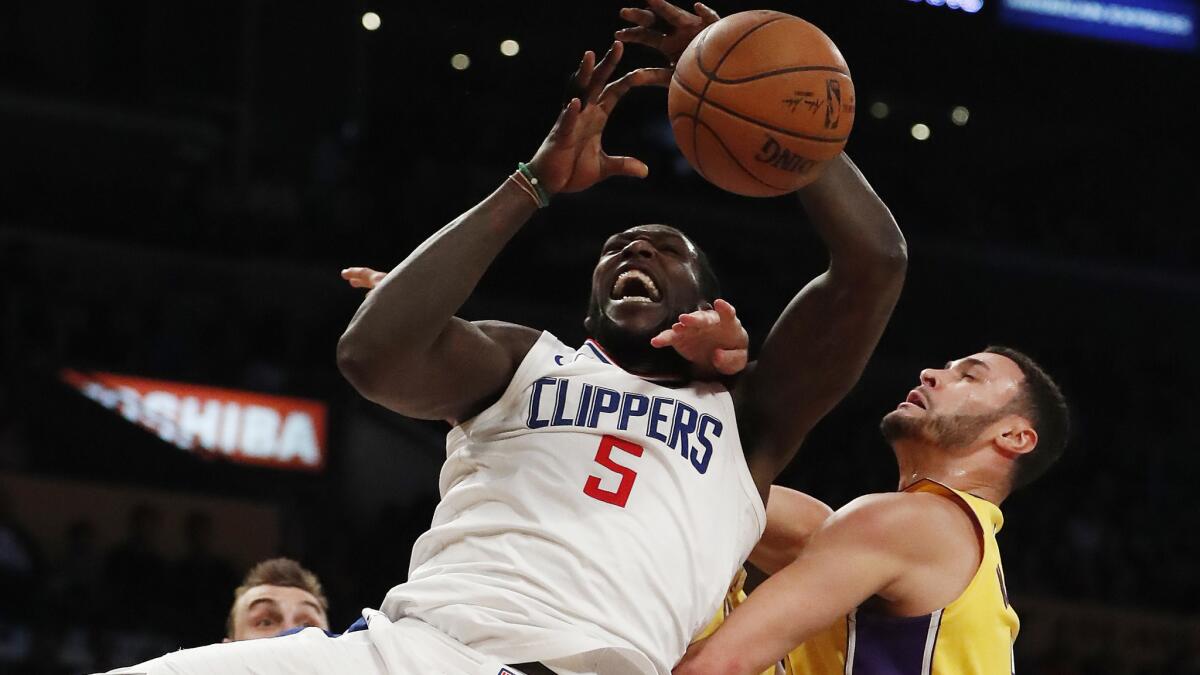 Clippers forward Montrezl Harrell is fouled by Lakers forward Larry Nance Jr. during the second half on Friday night.