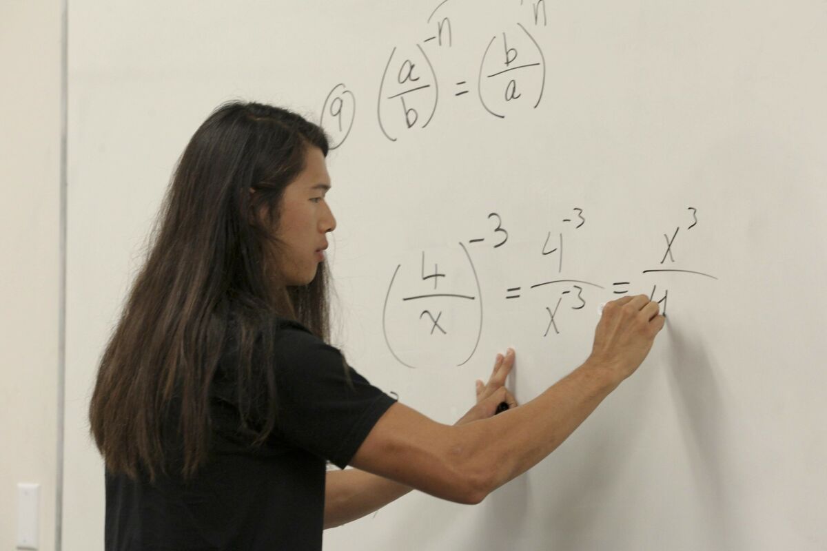 Tutor Austin Kruisheer works on an equation at San Diego State University