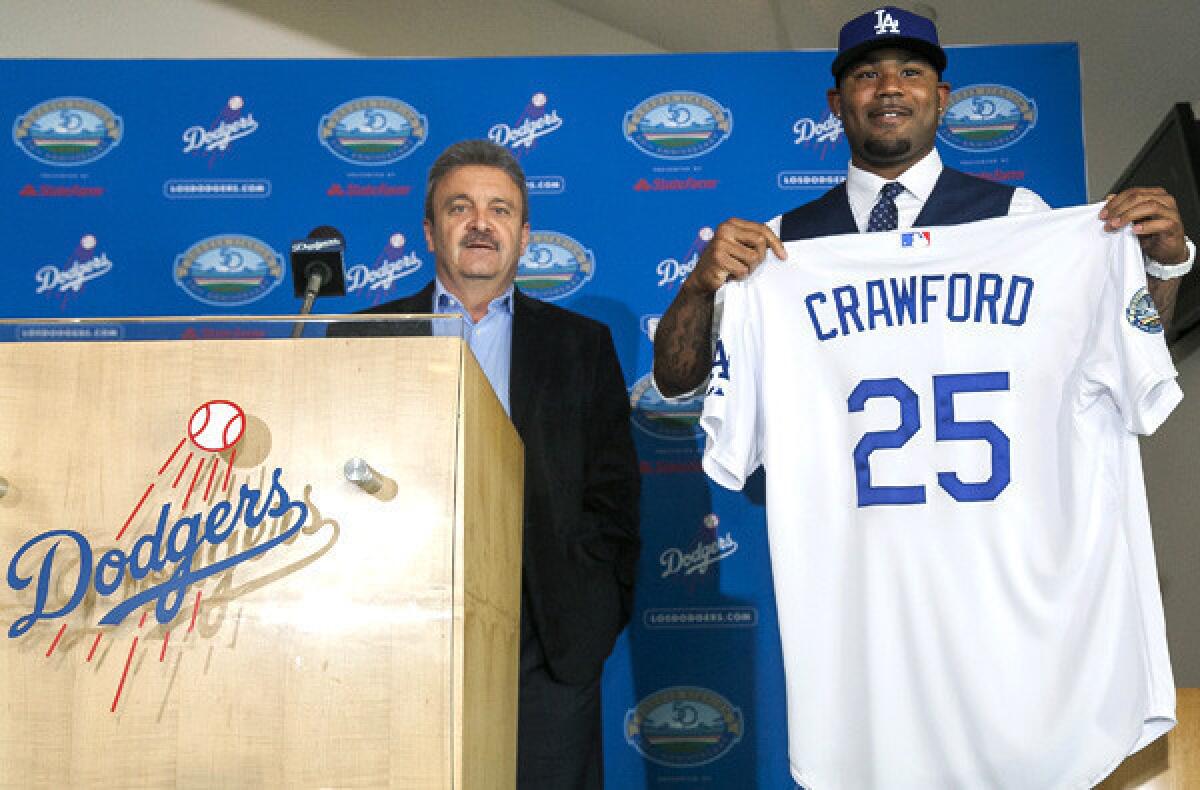 Dodgers General Manager Ned Colletti introduces Carl Crawford to the media on Friday at Dodger Stadium.