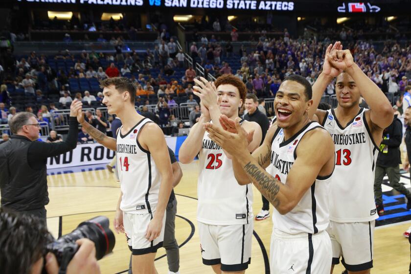 Orlando, FL - March 18: San Diego State's Keshad Johnson (0) and Jaedon LeDee (13) celebrate after being Furman during the second round of the NCAA Tournament in Orlando on Saturday, March 18, 2023.. (K.C. Alfred / The San Diego Union-Tribune)