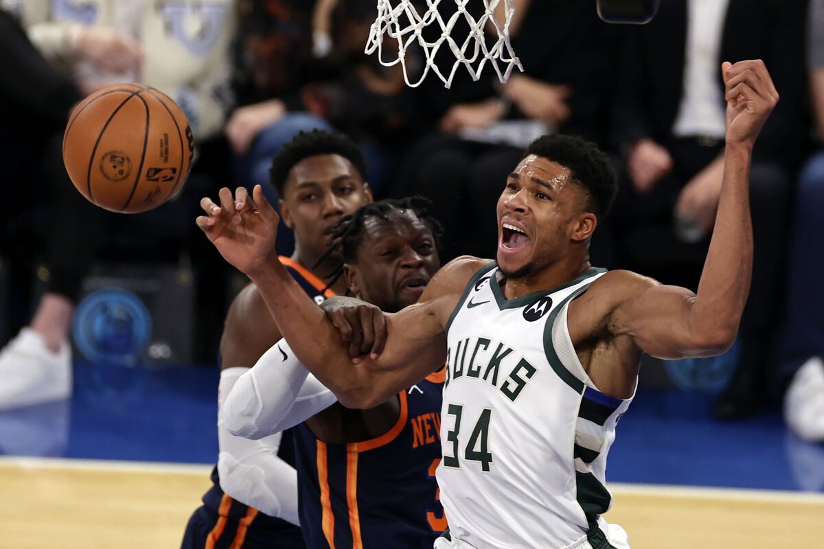 Milwaukee Bucks forward Giannis Antetokounmpo (34) reacts to being fouled by New York Knicks forward Julius Randle during the first half of an NBA basketball game Wednesday, Nov. 30, 2022, in New York. (AP Photo/Adam Hunger)
