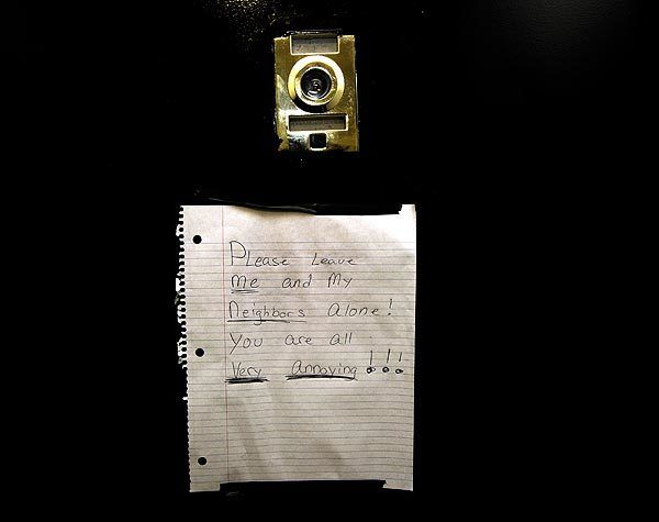 A sign is posted on the door next to the apartment of the housekeeper in the Dominique Strauss-Kahn case.