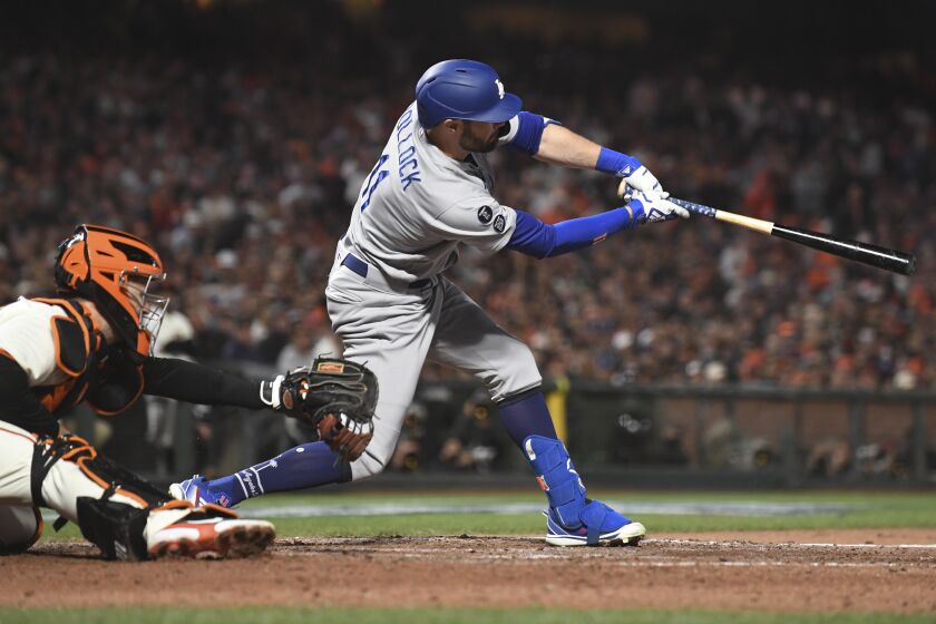 The Dodgers' AJ Pollock connects for a two-run double during the sixth inning of Game 2 of the NLDS on Oct. 9, 2021.
