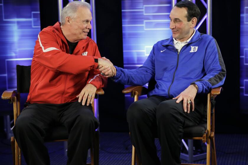 Wisconsin Coach Bo Ryan and Duke Coach Mike Krzyzewski share a handshake during a CBS Sports interview in anticipation of Monday's championship game.