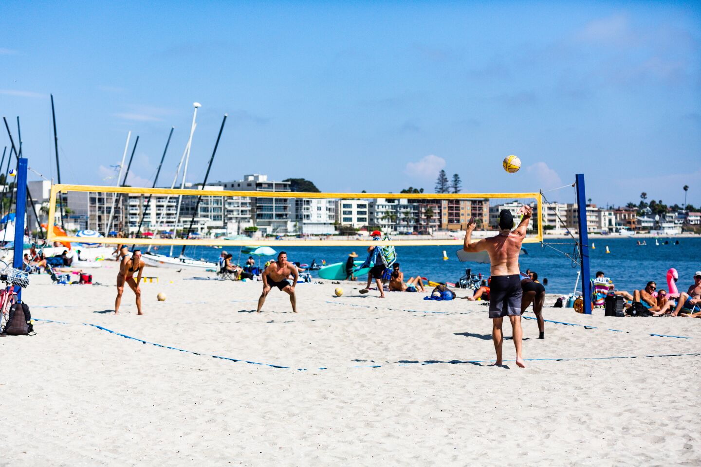 Beach volleyball players enjoy the sunshine at Sail Bay.