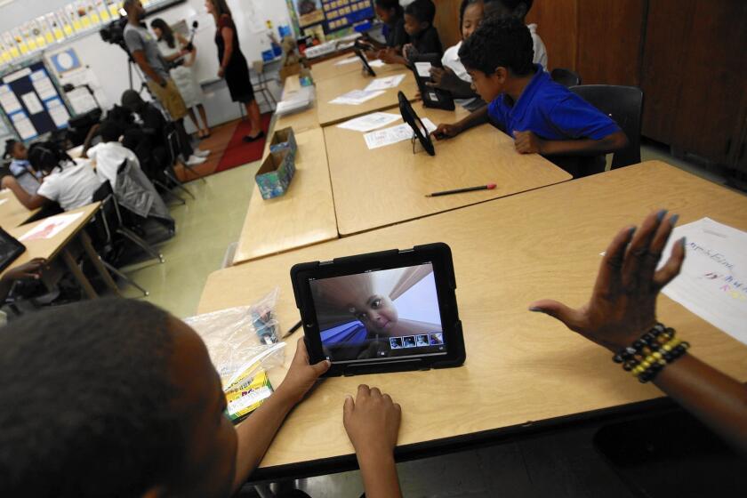 Muhammad Nassar Jr. takes a picture of himself as Karen Finkel's class explores the possibilities with their LAUSD-provided iPads at Broadacres Elementary in Carson.