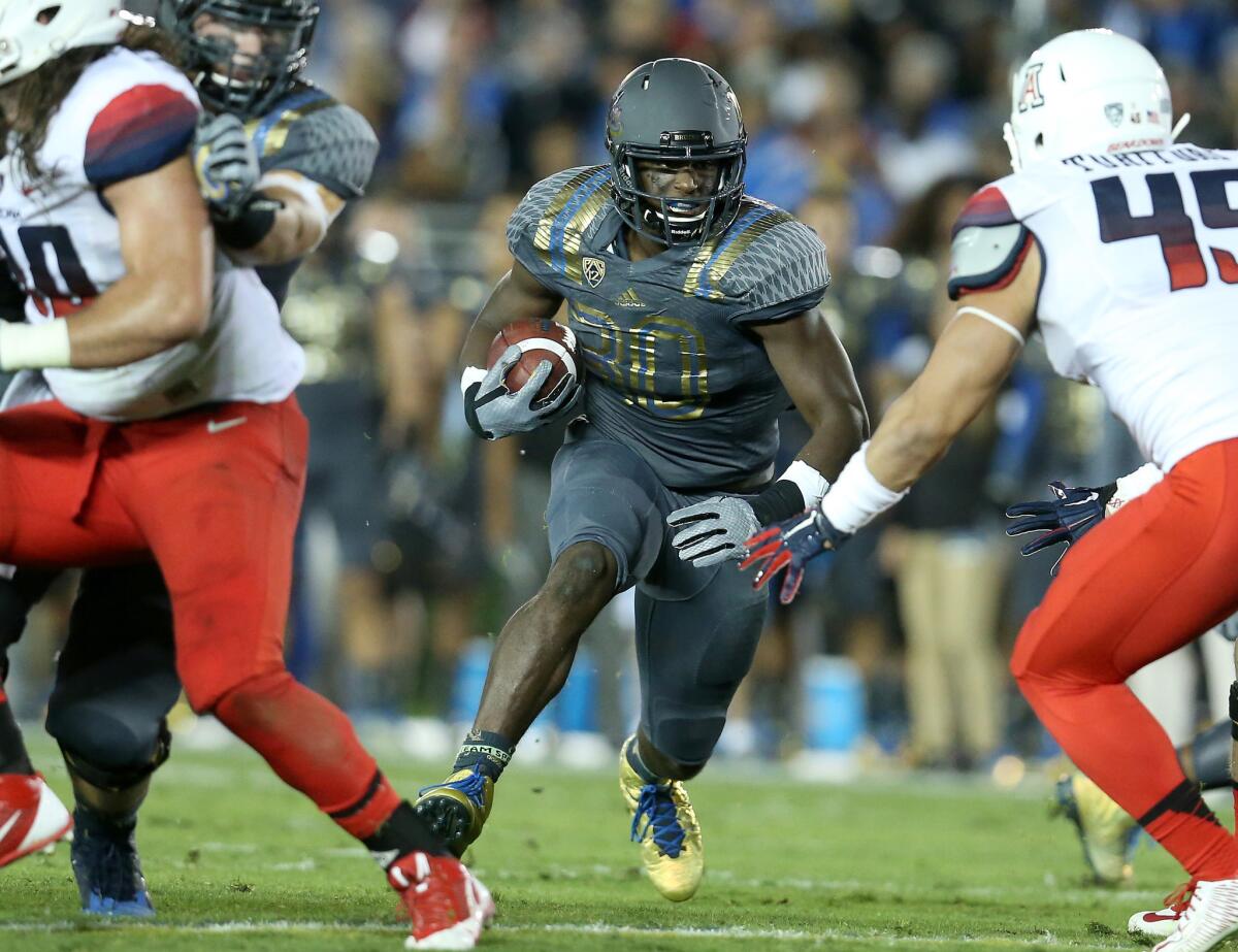 Myles Jack carries the ball against Arizona at the Rose Bowl on Nov. 1.