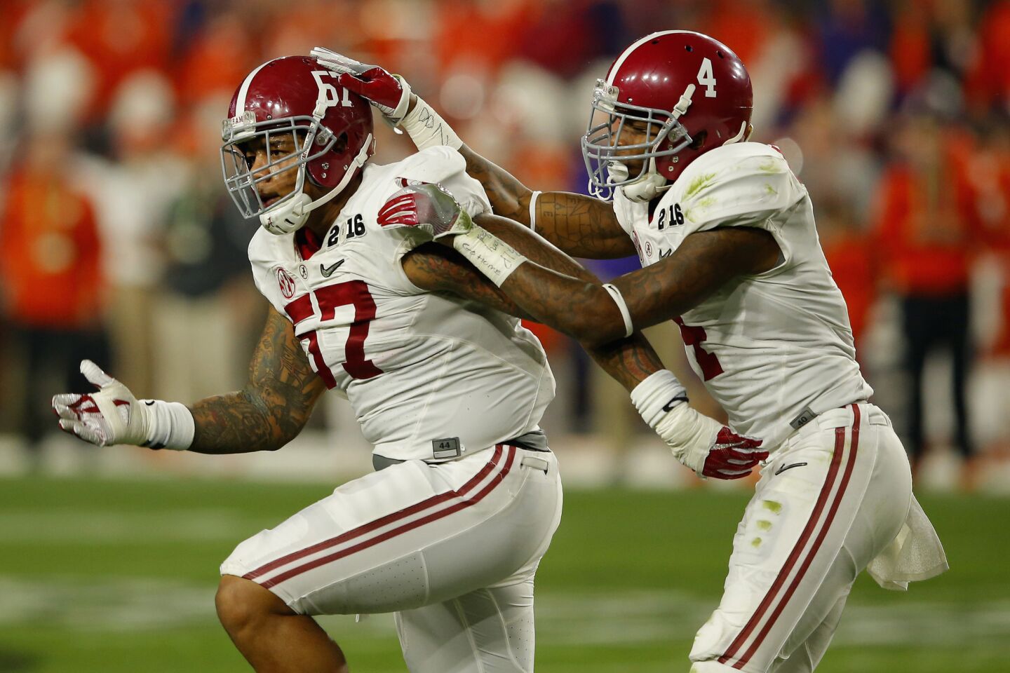 Alabama defenders D.J. Pettway (57) and Eddie Jackson (4) celebrate after a blocked field goal attempt.