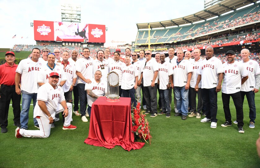Former Angels players pose for a photo during the 20th anniversary celebration of their World Series title.