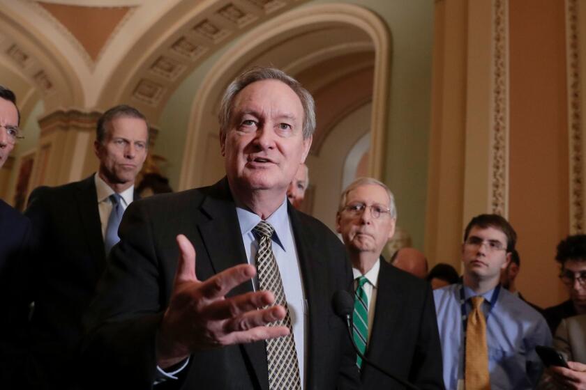 Sen. Mike Crapo, R-Idaho, chairman of the Senate Banking Committee, joined by, from left, Sen. John Barrasso, R-Wyo., Sen. John Thune, R-S.D., and Senate Majority Leader Mitch McConnell, R-Ky., right, talks to reporters as the Senate moves closer to passing legislation to roll back some of the safeguards Congress put in place to prevent a repeat of the 2008 financial crisis, during a news conference at the Capitol in Washington, Tuesday, March 6, 2018. (AP Photo/J. Scott Applewhite)
