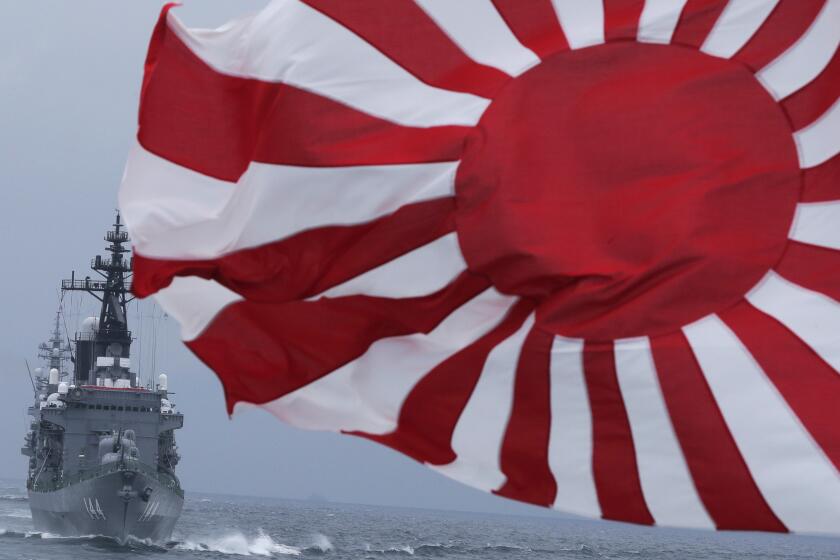 FILE - In this Oct. 14, 2012, file photo, Japan Maritime Self-Defense Force (JMSDF) escort ship "Kurama," left.