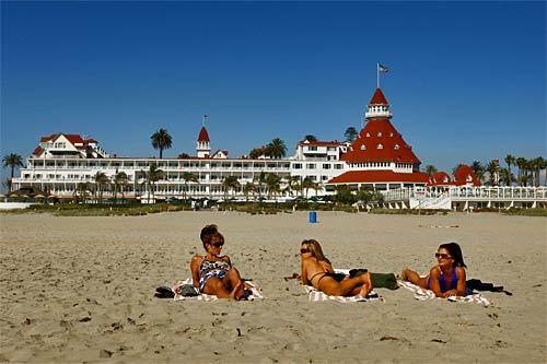 Coronado City Beach Coronado Bookended by military stations and parading past the storied Hotel del Coronado, this nearly two-mile stretch of Pacific Ocean sand is a great place to hobnob with summer crowds or escape them. Either way, you'll have room to play. One of San Diego County's widest beaches, it expands to 100 yards or more in spots along a spit between the U.S. Naval Air Station North Island and the Naval Amphibious Base. Depending on where you plant your umbrella, you can swim, surf, watch pelicans dive bomb for fish, wade in tide pools, barbecue or grab a fancy drink at a Hotel Del cafe. My favorite time is early morning, when Navy SEALs on training jogs may be the only souls you see. The sunsets? Fabulous. Along Ocean Boulevard, (619) 522-7346 (lifeguard service); www.coronado.ca.us. --Jane Engle