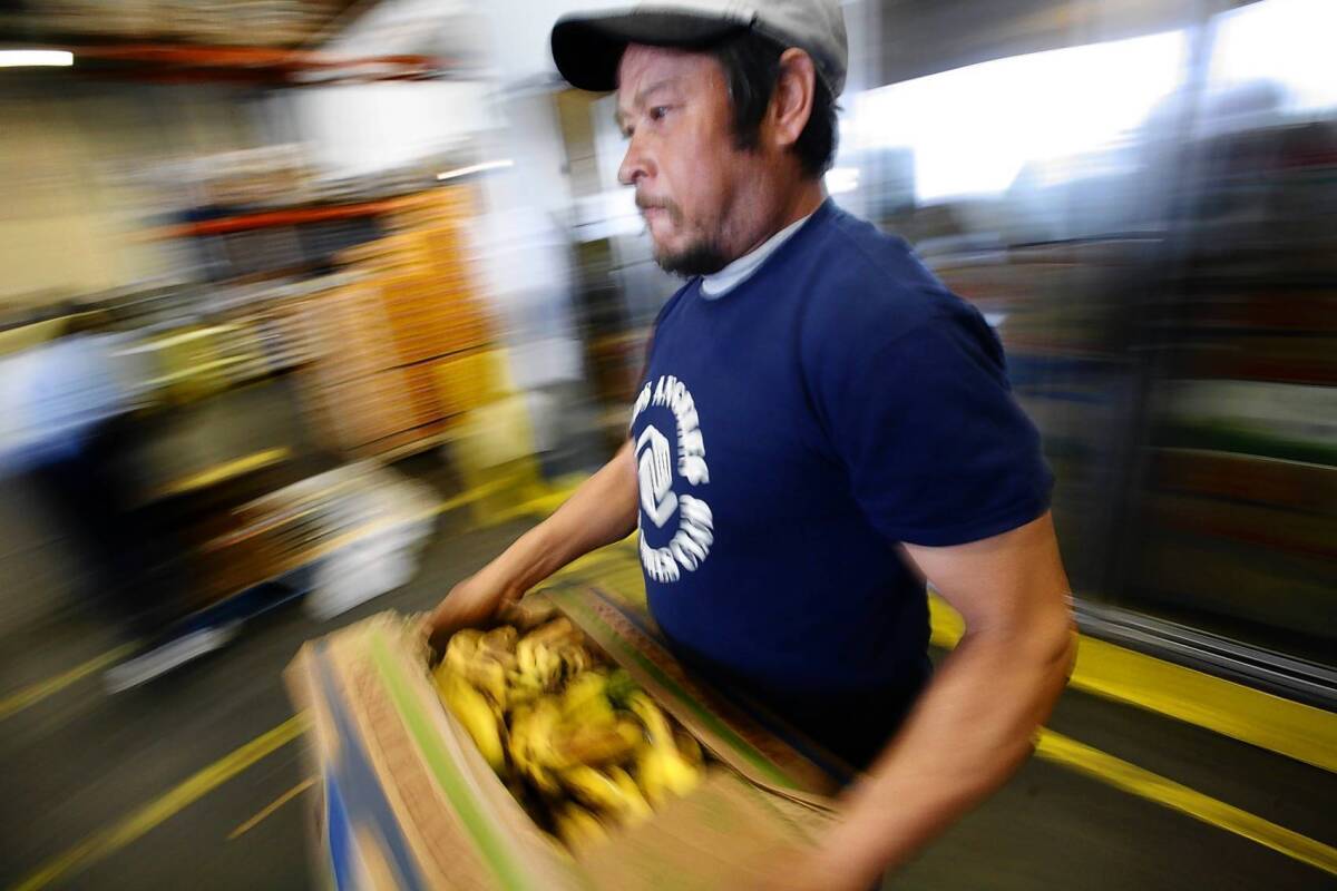 David Navarro of the Los Angeles Boys & Girls Club collects food items at the Los Angeles Regional Food Bank on 41st Street.