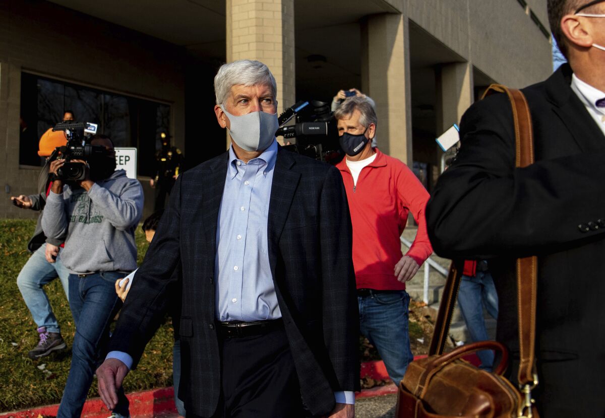 Former Gov. Rick Snyder walks past the media after his video arraignment on charges related to the Flint water crisis on Thursday, Jan. 14, 2021 outside the Genesee County Jail in downtown Flint. Snyder pleaded not guilty to misdemeanor charges of willful neglect of duty in Flint. (Cody Scanlan/The Flint Journal via AP)