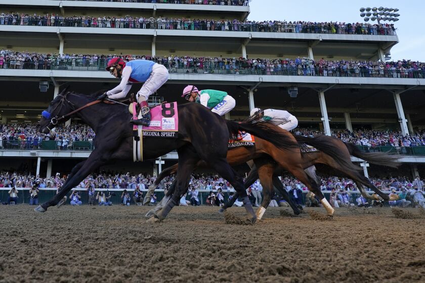 John Velazquez riding Medina Spirit leads Florent Geroux on Mandaloun and Flavien Prat riding Hot Rod Charlie to win the 147th running of the Kentucky Derby at Churchill Downs, Saturday, May 1, 2021, in Louisville, Ky. (AP Photo/Jeff Roberson)