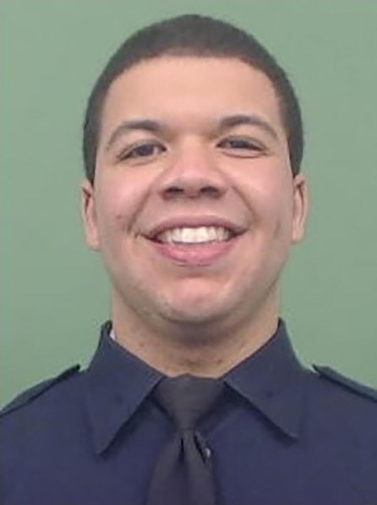 New York Police Department officer Jason Rivera smiles while in uniform