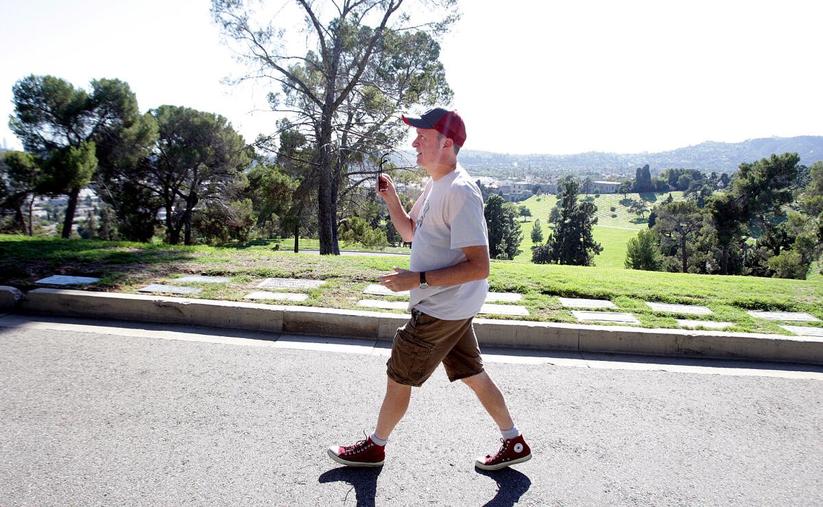 Author Paul Haddad, of Los Feliz, walks a favorite route of his through Forest Lawn Memorial-Parks & Mortuaries in Glendale on Friday, October 2, 2015. Haddad has written a book titled "10,000 Steps a Day in L.A.: 52 Walking Adventures" which includes a 5-mile, or 10,000-step route through Forest Lawn.