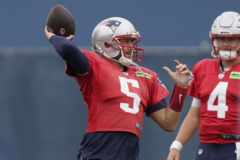 New England Patriots quarterback Brian Hoyer (5) winds up for a pass near quarterback Bailey Zappe (4) during an NFL football practice, Wednesday, Sept. 21, 2022, in Foxborough, Mass. (AP Photo/Steven Senne)