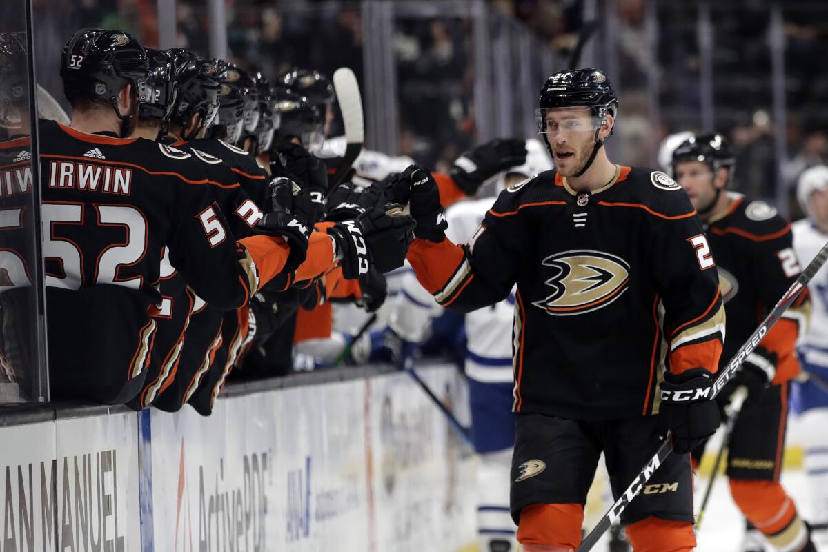 The Ducks' Carter Rowney is congratulated by teammates after scoring a first-period goal March 6, 2020.
