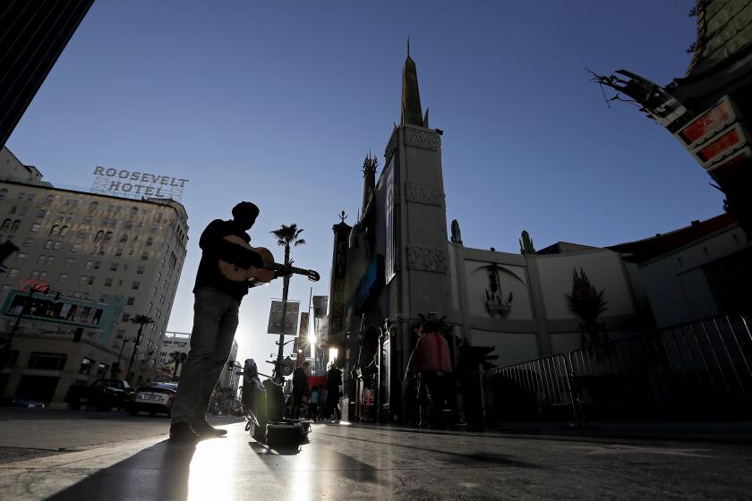 HOLLYWOOD, CALIF. -MAR. 17, 2020. Hollywood Boulevard n Hollywood is devoid of its usual tourist crowds on Tuesday, Mar. 17, 2020. Motor and foot traffic normally jams the famed street, but many shops, restaurants, theaters and attractions have temporaily closed as a safety measure against the coronavirus pandemic. (Luis Sinco/Los Angeles Times)