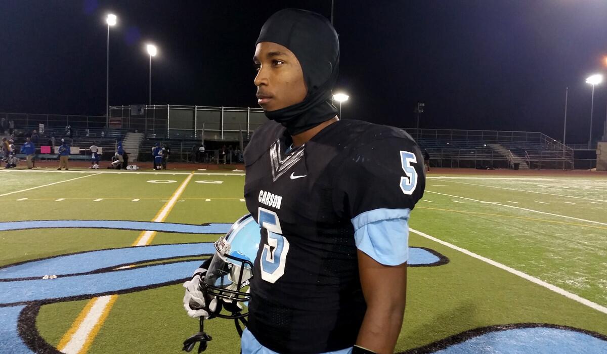 Carson wide receiver Jabari Minix gets set to warm up before the playoff game against Crenshaw on Friday night.