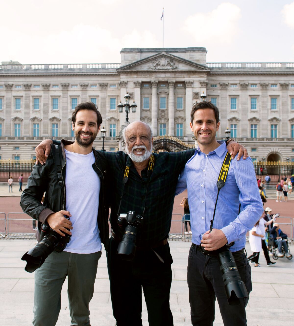Royal photographer Anwar Hussein, center, with photographer sons Samir Hussein, left, and Zak Hussein, in London in 2020