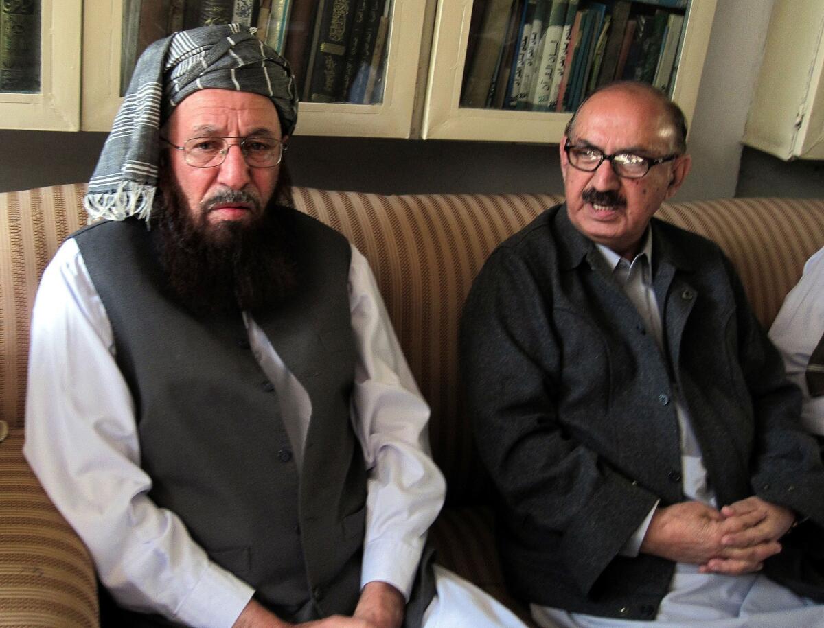 Pakistani Taliban representative Maulana Sami ul-Haq, left, meets with the special assistant to Pakistan's prime minister, Irfan Siddiqui, during peace talks outside Peshawar.