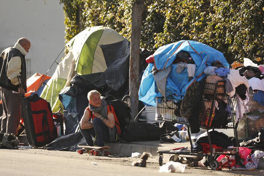 VENICE, CA - JANUARY 30, 2020 Homeless people living on 3rd avenue near Rose Avenue in Venice prepare for a scheduled clean up. We are talking to homeless people in Venice about enforcement of sidewalk sleeping rules. (Al Seib / Los Angeles Times)