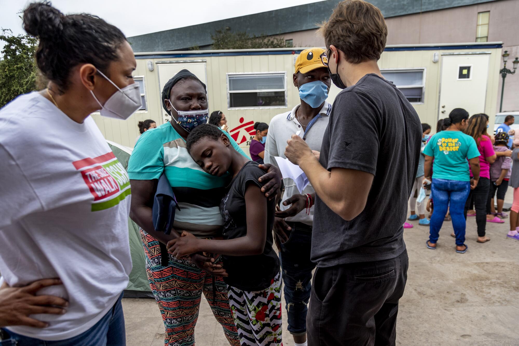 Felicia Rangel-Samponaro with staffer Alex Norman helps Claudia Chery's daughter Sarania Felix