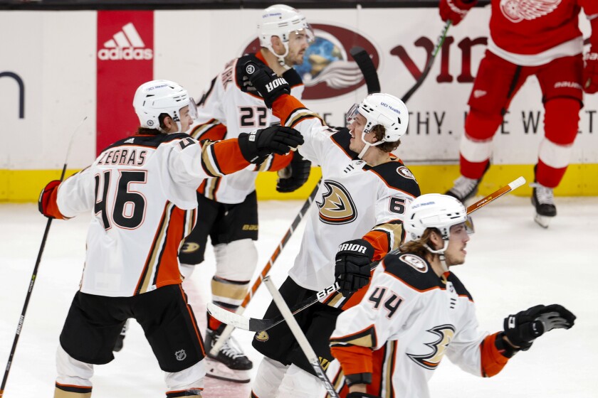 Anaheim Ducks forward Rickard Rakell (67) celebrates with forward Trevor Zegras (46) after his shootout goal against the Detroit Red Wings during an NHL hockey game Sunday, Jan. 9, 2022, in Anaheim, Calif. (AP Photo/Ringo H.W. Chiu)