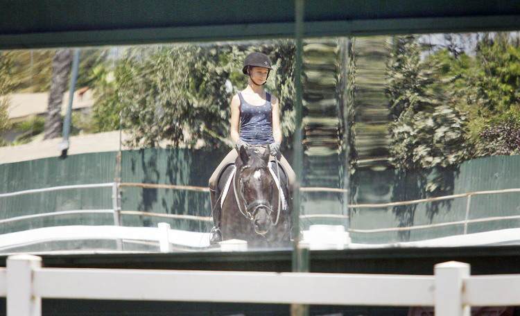 Rison Harrison rides on one of her favorite horses, Kantor, at Paddock Riding Club in Los Angeles on Thursday, August 17, 2011. Harrison has been riding since she was five-years-old. She will be competing in the Dressage Equitation Finals next week in Chicago.