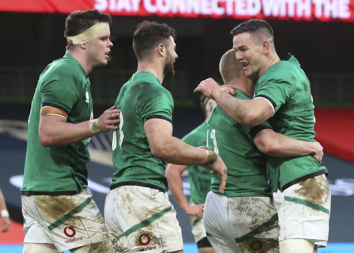 Ireland's Keith Earls celebrates scoring his side's first try of the game with team-mate Jonathan Sexton, during the Autumn Nations Cup rugby match between Ireland and Scotland, at the Aviva Stadium, in Dublin, Ireland, Saturday, Dec. 5, 2020. (Brian Lawless/PA via AP)