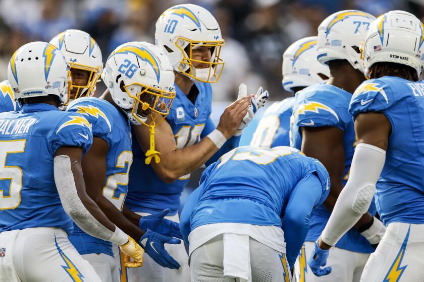 Chargers quarterback Justin Herbert (10) plays with a splint on his left middle finger late in the game against the Raiders.