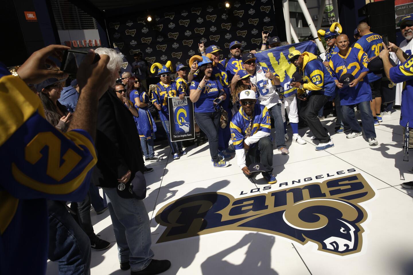 Los Angeles Rams fans pause for photos with the team's logo at a 2016 NFL football draft party Thursday, April 28, 2016 in Los Angeles. (AP Photo/Jae C. Hong)
