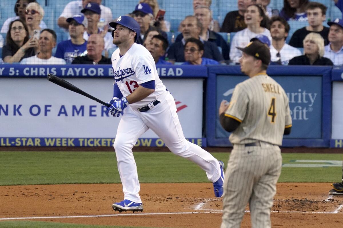 The Dodgers' Max Muncy and Padres starting pitcher Blake Snell watch the flight of Muncy's second-inning homer July 1, 2022.