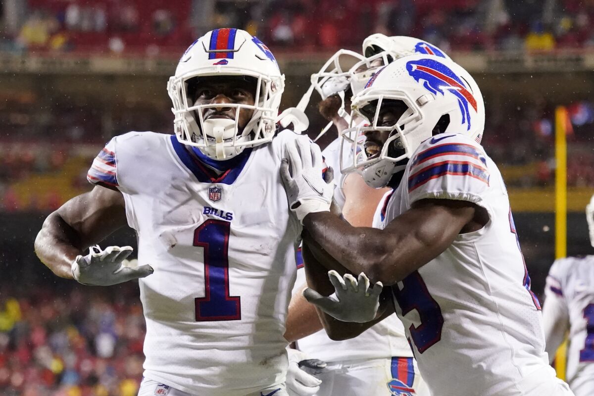 Buffalo Bills wide receiver Emmanuel Sanders (1) is congratulated by Tremaine Edmunds, right, after scoring during the second half of an NFL football game against the Kansas City Chiefs Sunday, Oct. 10, 2021, in Kansas City, Mo. (AP Photo/Charlie Riedel)