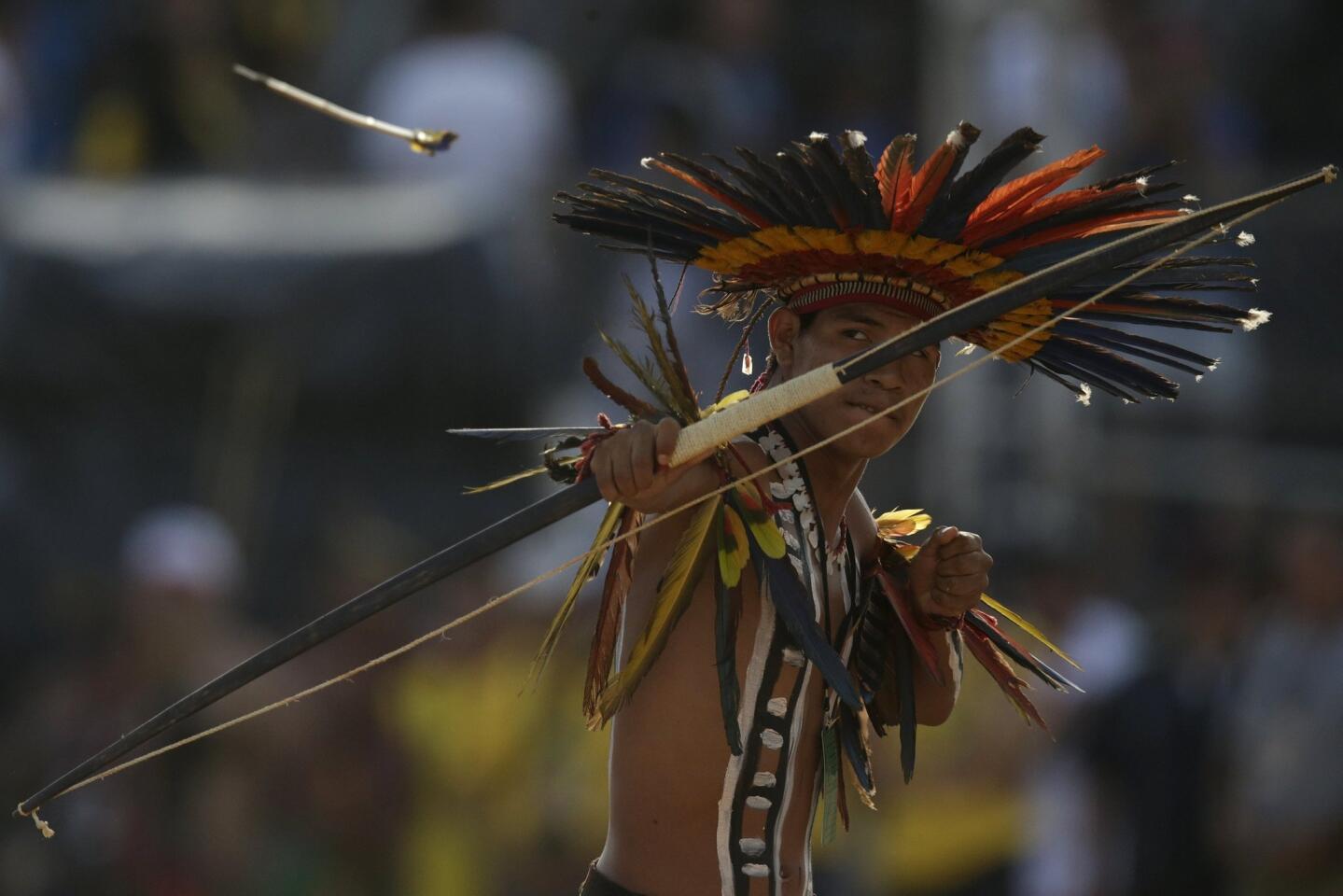 An indigenous man from the Bororo people fires an arrow during the bow-and-arrow competition at the first World Games for Indigenous Peoples in Palmas