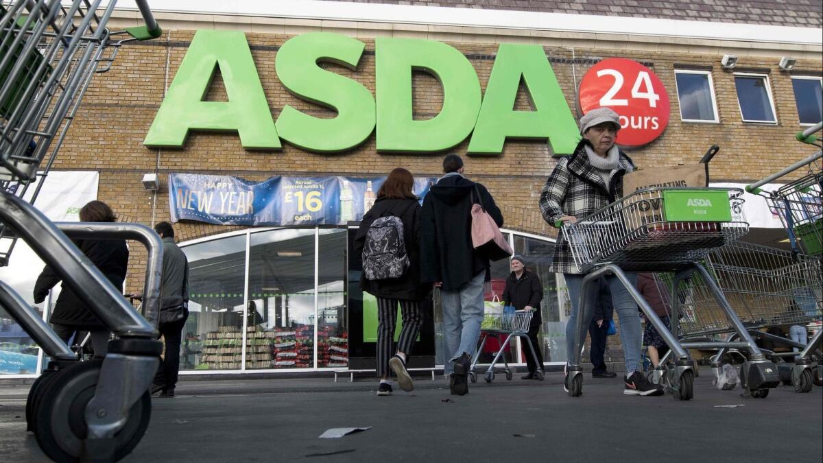 Customers come and go at a branch of Asda supermarket in south London on Jan. 10.
