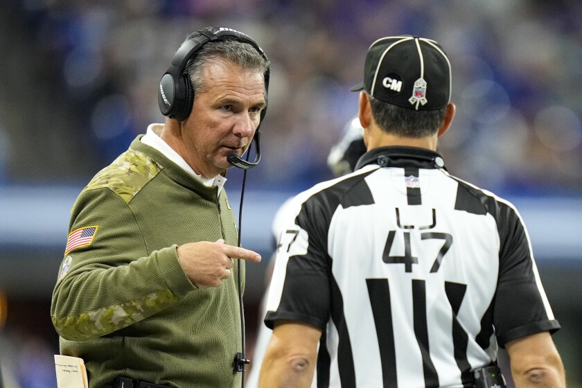 Jacksonville Jaguars head coach Urban Meyer talks with line judge Tim Podraza (47) in the second half of an NFL football game against the Indianapolis Colts in Indianapolis, Sunday, Nov. 14, 2021. (AP Photo/AJ Mast)