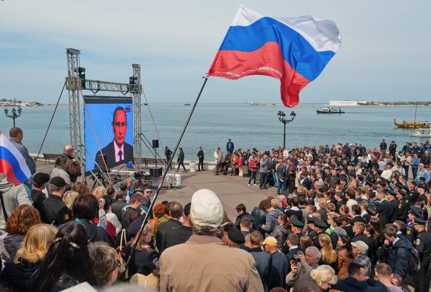Crimea residents gather at the seafront in Sevastopol to watch a telecast of a live call-in program featuring Russian President Vladimir Putin.