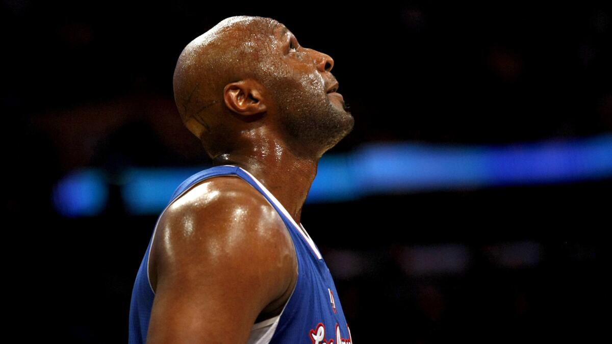 Lamar Odom checks the scoreboard during a game with the Clippers on Nov. 2, 2012.