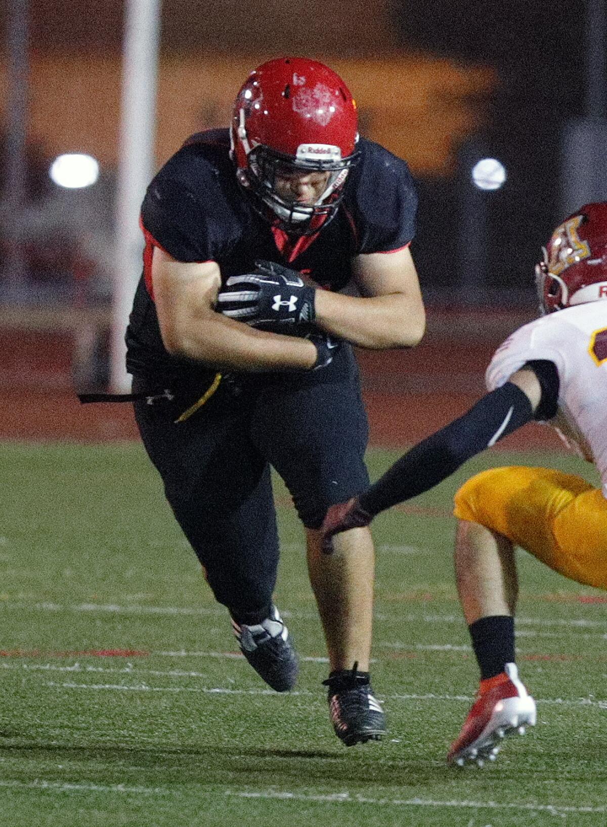 Glendale's Dennis Perez carries the ball against Arcadia in a Pacific League football game at Glendale High School on Thursday, October 3, 2019.