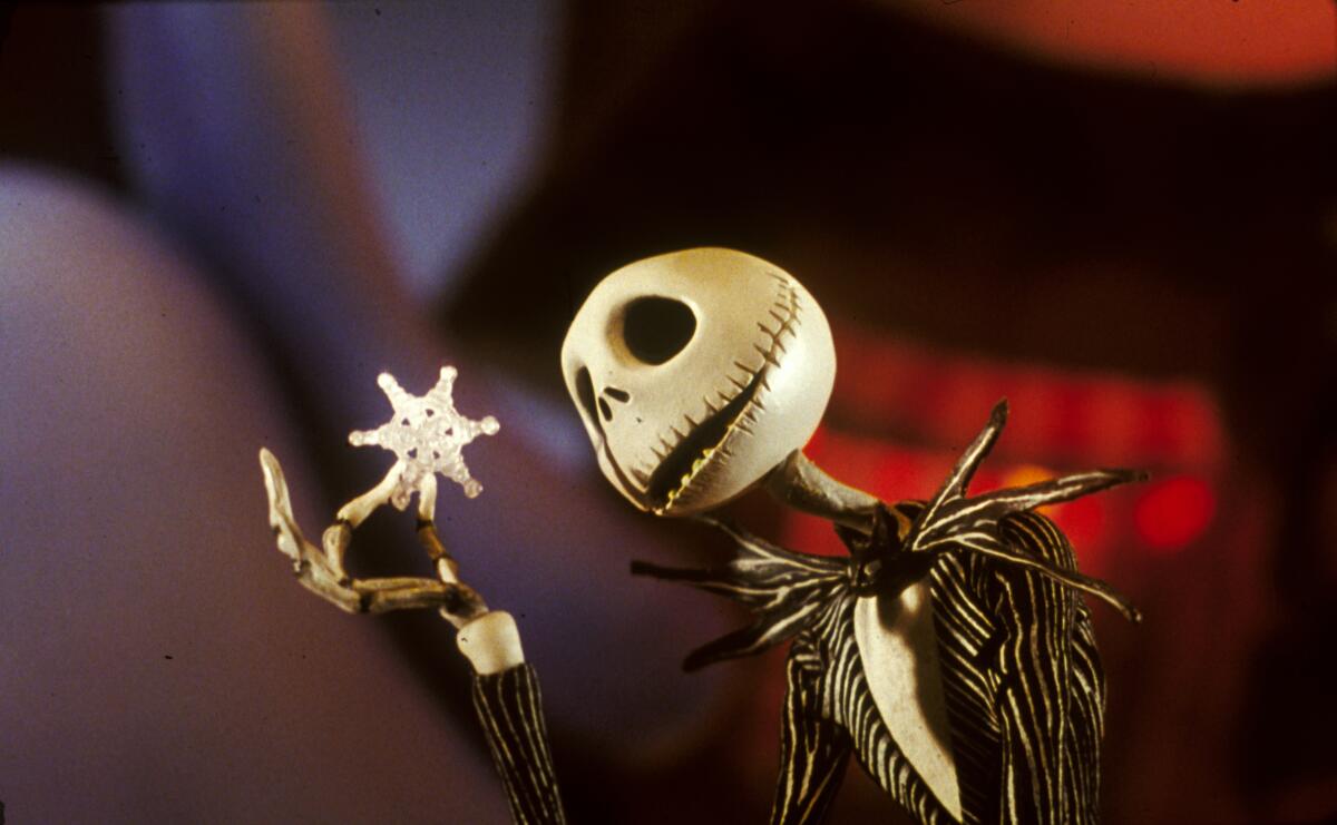 Jack Skellington looks at a snowflake in the animated movie "The Nightmare Before Christmas" (1993).