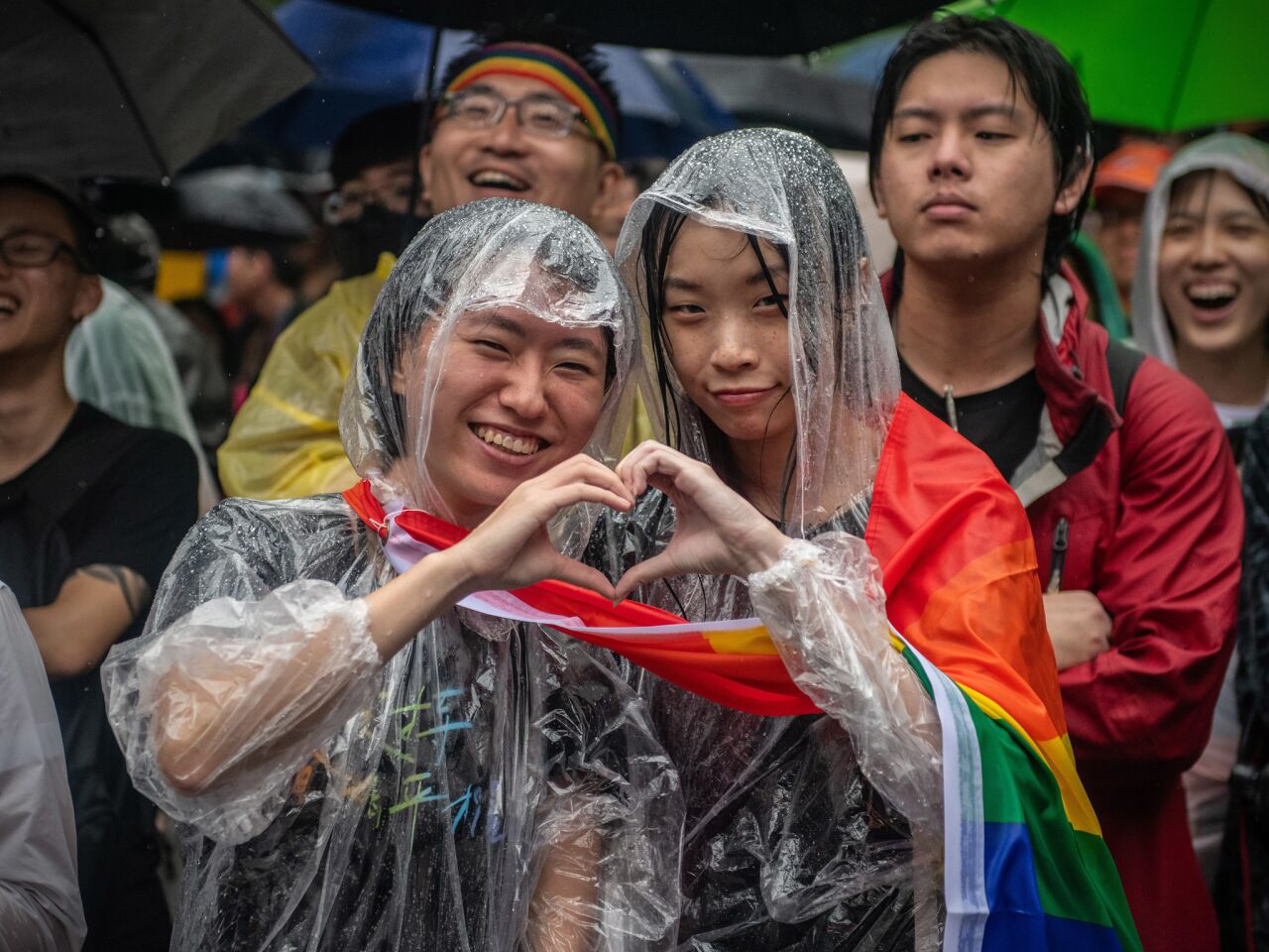 Women in Taipei form a heart with their hands after Taiwan's parliament voted to legalize same-sex marriage.