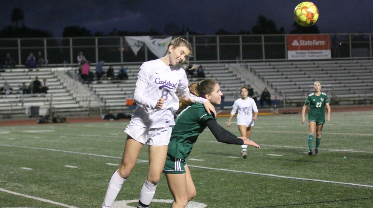 Carlsbad senior Marisa Bubnis goes over the top for a header.